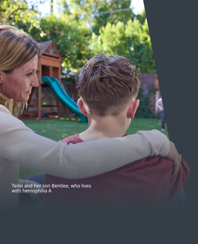 Image of woman with arm around teenage son